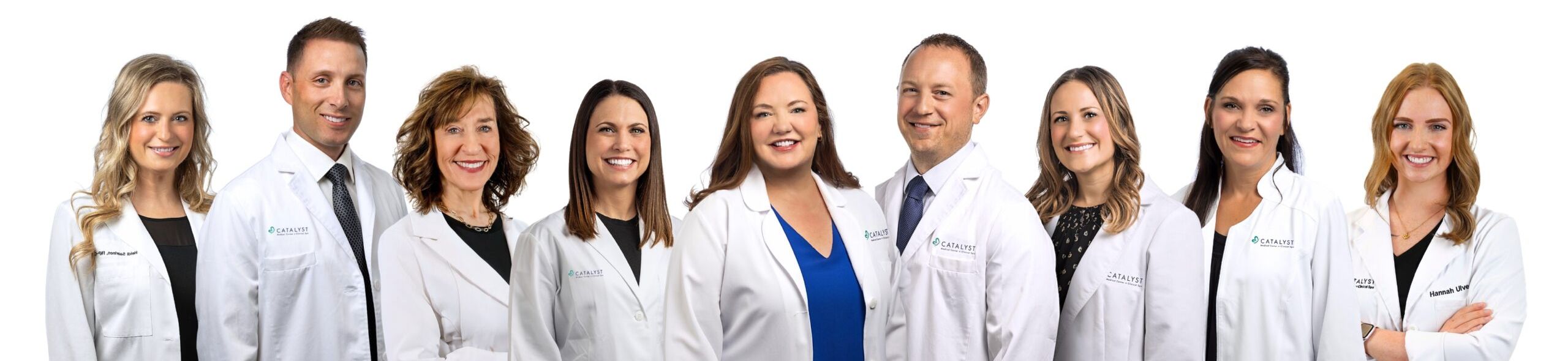 Catalyst Medical Center medical providers - men and women wearing white Catalyst lab coats, smiling at the camera.